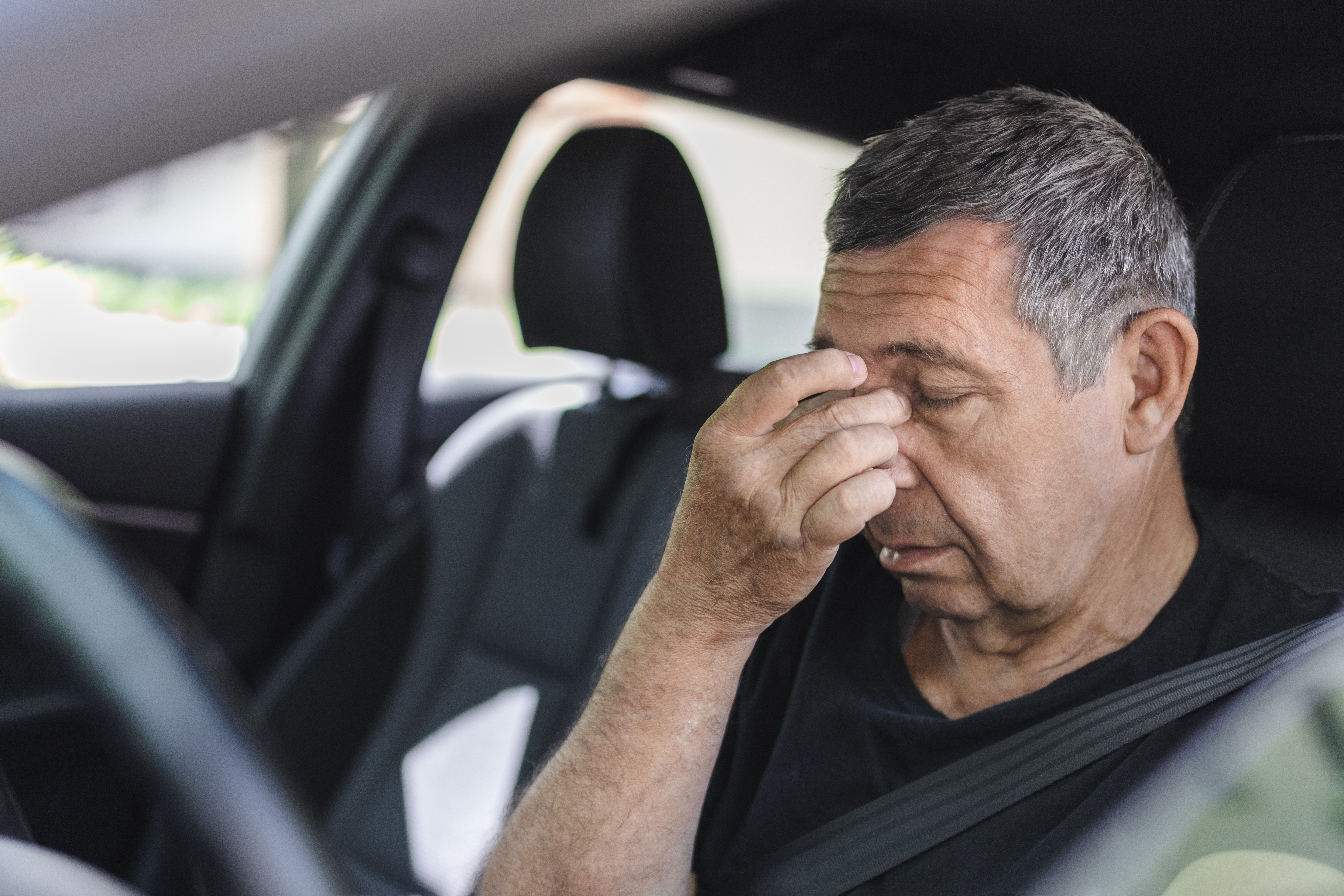 tired-pensioner-dring-in-a-car-